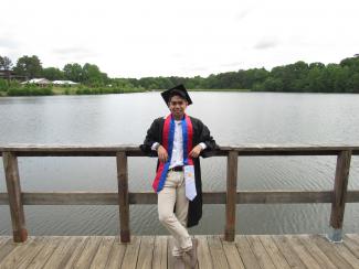 Graduate in front of lake
