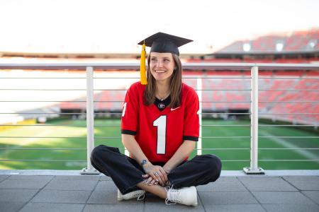 graduate in front of Sanford 